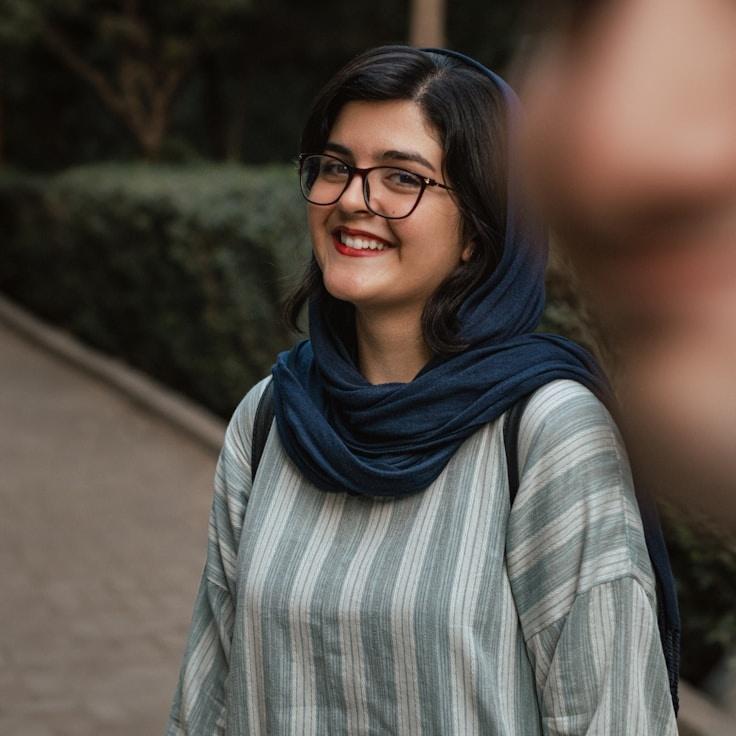 Avery Singh, Lead Design Curator at QuietFiberCanvas, reviewing corporate floral arrangements